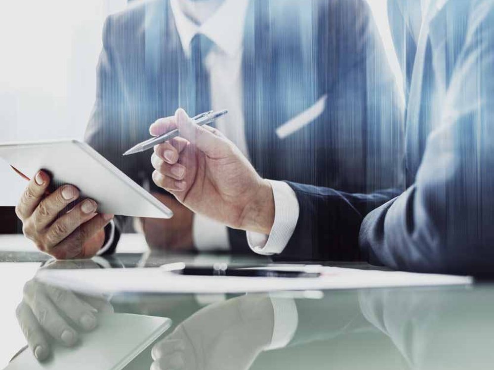 Harb Silm consultants reviewing documents with a client
